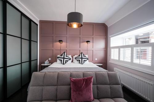 a bedroom with a large bed and a couch at The Cock and Bull in Balmedie