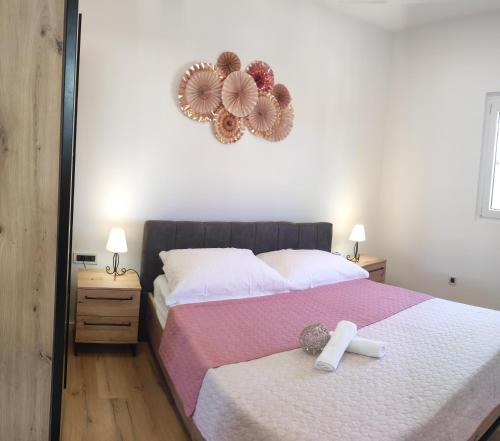 a cross on a bed in a bedroom with a mirror at Apartman Ivana in Split