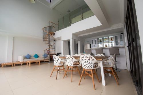 a dining room with a table and chairs at WDC APARTHOTEL - BUEA in Buea