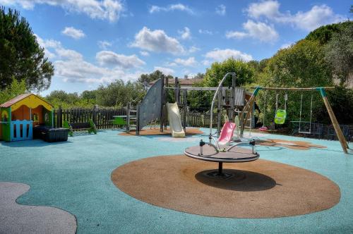 a small playground with a play park with a slide at "AU HAVRE DE PAIX" 5 étoiles Prestige jacuzzi, hammam, sauna, PISCINE chauffée Mougins Cannes Grasse in Mougins