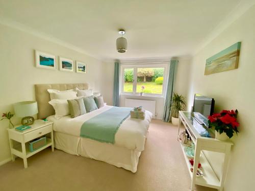 a bedroom with a large bed and a window at Ranmore Rise Retreat in Westcott