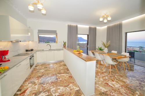 a kitchen and dining room with a table and chairs at Blue Horizon Kisamos Deluxe Apartment in Kissamos