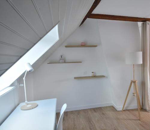 a white room with a table and a lamp at Welcome Home in Linas