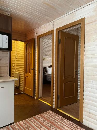 a small room with a door and a bedroom at Котедж in Vorokhta