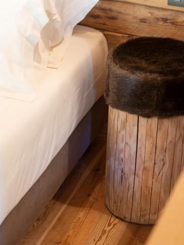 a bedroom with a bed and a trash can at Gran Baita Hotel & Wellness in Courmayeur