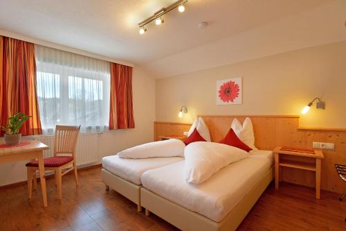une chambre d'hôtel avec un lit et un bureau dans l'établissement DORFSTUDIO Apartments, à Söll