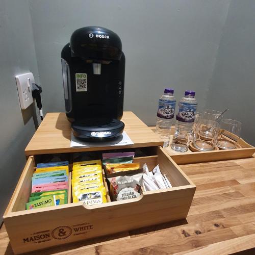 a coffee maker sitting on top of a box on a table at Beinn Mhor Lodge, 63 Culduthel Road in Inverness