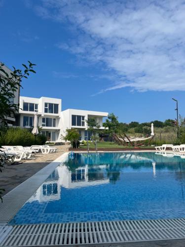 a large swimming pool in front of a building at Ancient well in Sozopol