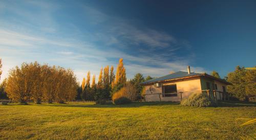 a small house in the middle of a field at Posada Los Mimbres in Gaiman
