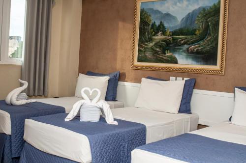 Säng eller sängar i ett rum på Hotel Portinari Ponte da Amizade