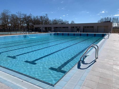 a large swimming pool in front of a building at KASANZAS in Fuentespina