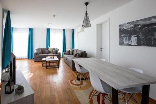a living room with a table and a couch at Green Nature Hotel & Apartments in Sarajevo