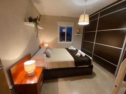 a small bedroom with a bed and a night stand at Robles home in Málaga