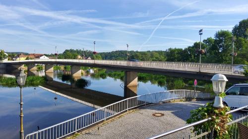 a bridge over a river with a car on it at Hotel-Café 3 Kronen in Burglengenfeld