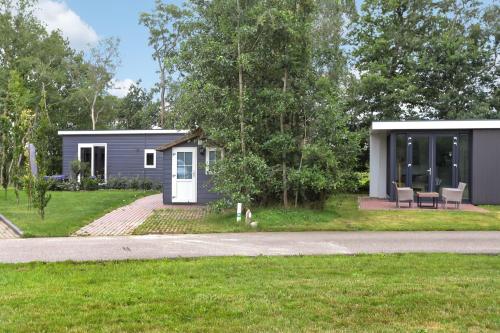 a tiny house in the middle of a yard at Landelijk chalet 87 in Oosterwolde