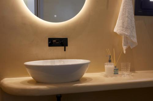 a bathroom with a bowl sink on a counter at Grand-Mere Calliope in Fira