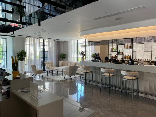 a lobby with chairs and a bar in a building at Rozafa Palace Hotel in Sarandë