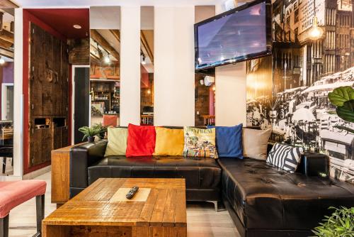a living room with a couch and a tv at Samesun Montreal Hotel & Hostel in Montréal