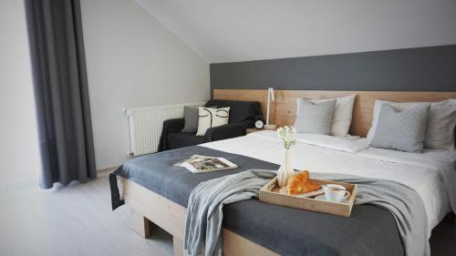a bedroom with a large bed with a tray on it at Rezydencja Pod Ochorowiczówką B&B in Wisła