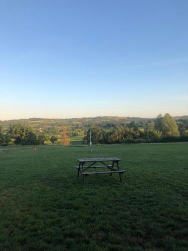 a picnic table in the middle of a field at Maison indépendante in Noyant-dʼAllier