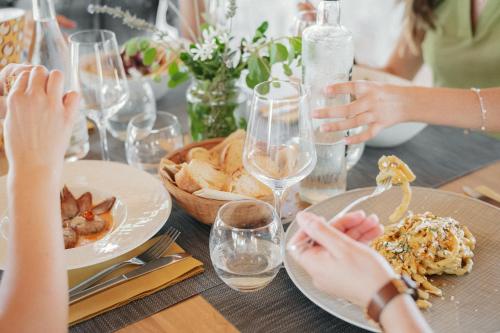 a group of people sitting at a table with plates of food at L'Oasi Villaggio Albergo in Favignana