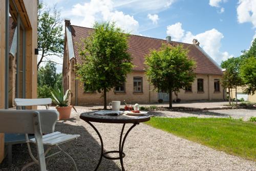a patio with a table and chairs in front of a house at FELDGANG ein Gästehaus! in Upahl
