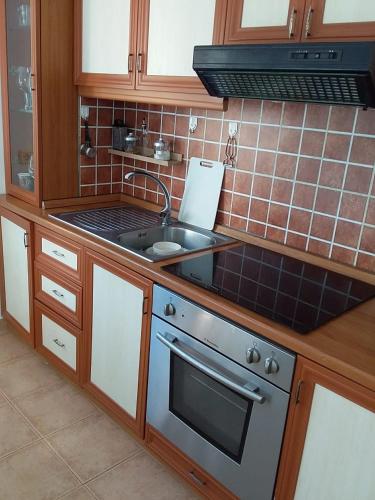 a kitchen with a sink and a stove at Lavender Home in Golem