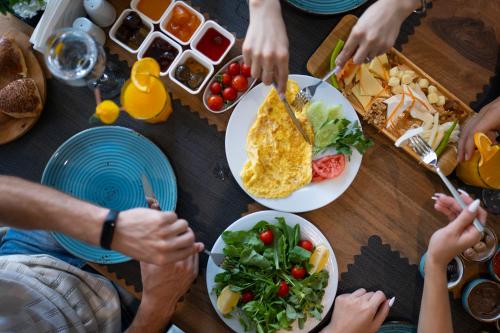 a group of people sitting around a table eating food at Antalya City Hotel & Spa in Antalya