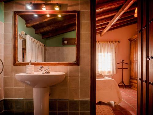 ein Badezimmer mit Waschbecken, Spiegel und Badewanne in der Unterkunft La Cañada del Valle del Jerte in Navaconcejo