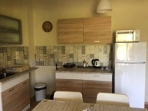 a kitchen with a refrigerator and a table and chairs at Casa Angela in Primorsko