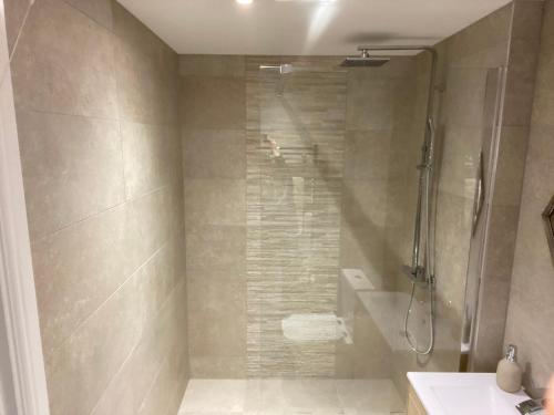a bathroom with a shower and a sink at Newly Refurbished Entire Apartment - South Gosforth, Newcastle in High Heaton