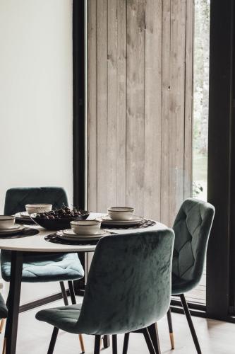 a dining room with a table and chairs at Dūņu Krogs in Ādaži