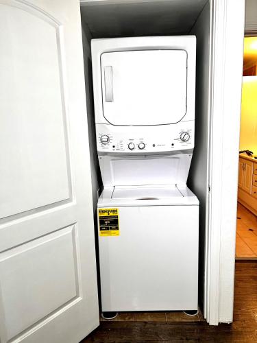 a microwave oven sitting on top of a refrigerator at Newly Remodeled spacious units, minutes from mountains, inlet, downtown and airport in Anchorage