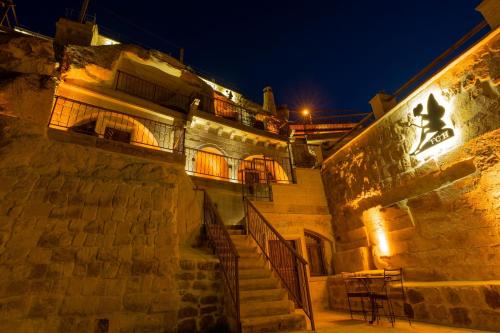 a building with stairs and a table on the side at Fairyland Cave Hotel in Goreme