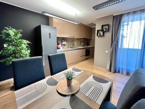 a living room with a table and chairs and a kitchen at City Center Apartments in Plovdiv