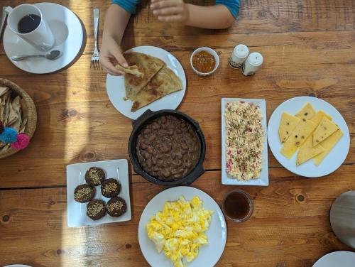 a wooden table with plates of food on it at Talist Siwa in Siwa