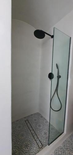 a glass shower with a lamp in a room at Halki Sea Breeze - a waterfront villa in Halki