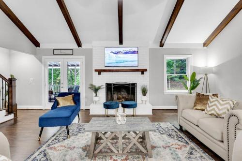 a living room with a couch and a fireplace at Lakefront, Saltwater Pool, Backyard Oasis, Private Dock, Home Gym in Flowery Branch