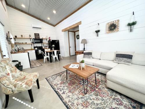 a living room with a couch and a table at Hummingbird Haus - Hill country views on 20 acres with firepit in Spring Branch