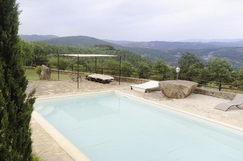 a swimming pool with a view of the mountains at Villa Betta by Mmega in Lugnano