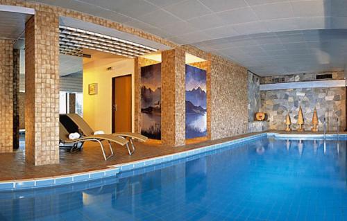 a large swimming pool in a hotel room at Hotel Austria in Niederau