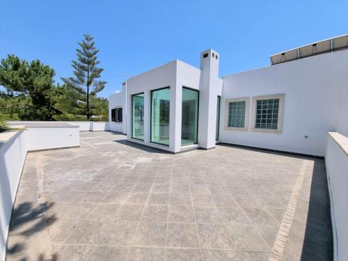 a large patio in front of a white building at Villa Fati With Pool by Vacationy in Troia