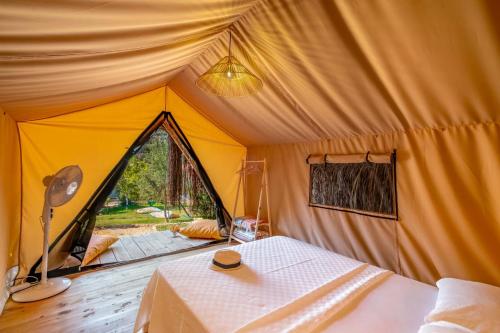 a room with a tent with a table in it at Kaş Joy Glamping in Kas