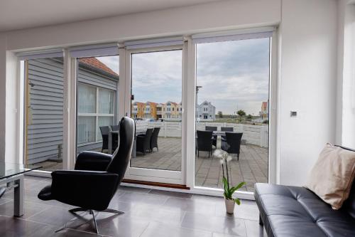 a living room with sliding glass doors with a patio at Eksklusiv ferielejlighed in Rudkøbing