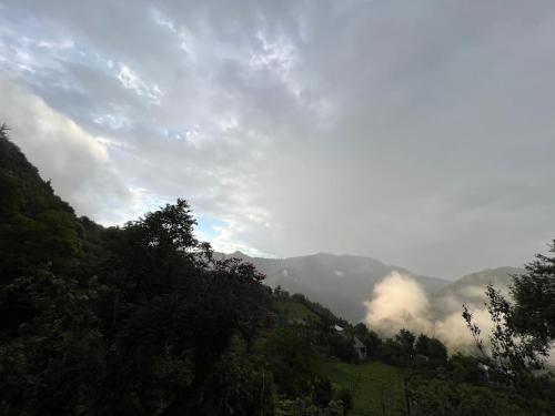 a view of a mountain with clouds in the sky at Woodhide - Cottages near Batumi, Georgia in Zeda Ch'khutunet'i