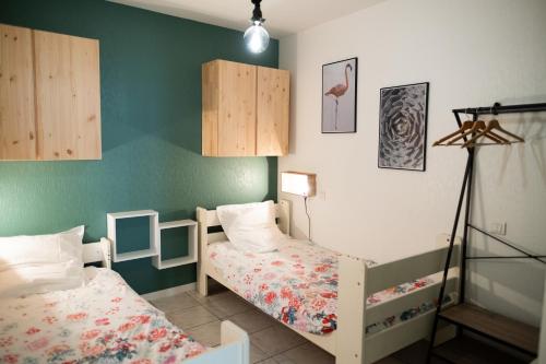 1 Schlafzimmer mit 2 Einzelbetten und einer Lampe in der Unterkunft ColorPop - Netflix Wifi Tout équipé - Appart Pézenas Centre in Pézenas