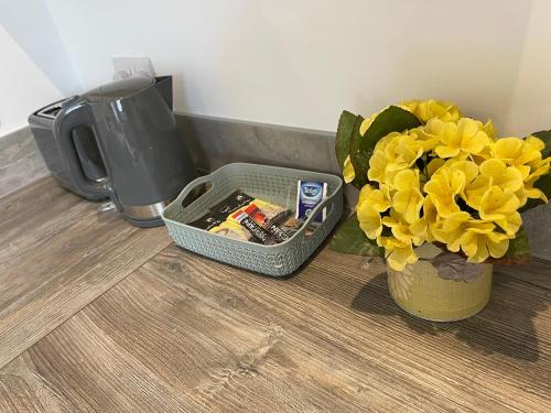 a vase filled with yellow flowers next to a blender at Albion Boutique Guest House in Sunderland