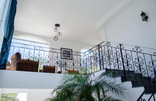 a stairway with a black and white railing at Hotel Rio Atlixco in Atlixco
