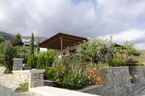 a house with a garden with flowers and plants at Krinakia Villas in Xerokampos