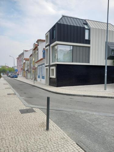 a building on the side of a street at Casa Aveiro Modern House in Aveiro